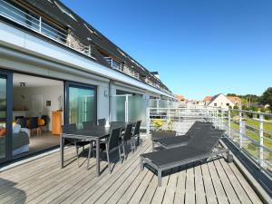 a balcony with a table and chairs on a building at Apartment Greens 103 with parking by Interhome in Mispelburg