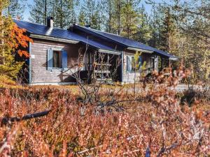 a small house in the woods with a field at Holiday Home Salakolo 2 by Interhome in Ruka