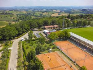 a city with a lot of green grass and trees at Camping Il Boschetto Di Piemma in San Gimignano