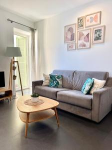 a living room with a couch and a table at Les Sablettes in Menton
