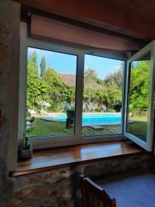 two windows in a room with a view of a pool at Errotazar apartamento M in Alsasua