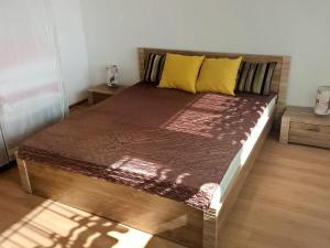 a large bed in a room with a wooden floor at Holiday Home Smołdziński Las by Interhome in Smołdziński Las