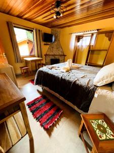 A bed or beds in a room at Pousada Magia da Montanha