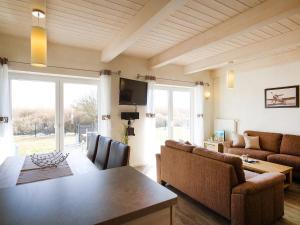 a living room with a table and a couch at Holiday Home Langeneß by Interhome in Dagebüll