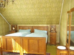 a bedroom with a wooden bed and two night stands at Holiday Home Valasska Bystrice by Interhome in Valašská Bystřice