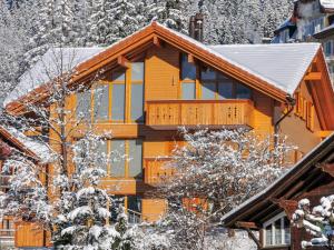 ein großes Holzhaus mit Schnee darauf in der Unterkunft Apartment Fortuna by Interhome in Wengen