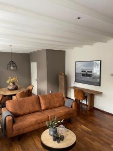 a living room with a couch and a table at Vakantie appartement Sunndays in Valkenburg