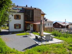 a bench in front of a house at Apartment Vitg Grond A2 by Interhome in Flims