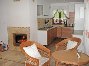 a kitchen with a table and chairs and a fireplace at Holiday Home Borowikowa by Interhome in Sasino
