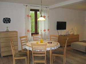 a kitchen and dining room with a table and chairs at Holiday Home Borowikowa by Interhome in Sasino