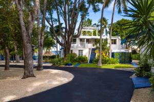 a house with palm trees in front of a driveway at Azul del Mar in Key Largo