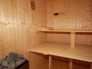 - un sauna avec une étagère en bois et quelques rochers dans l'établissement Holiday Home Almvilla by Interhome, à Sirnitz-Sonnseite