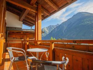 einen Tisch und Stühle auf dem Balkon einer Hütte in der Unterkunft Apartment Alpin-5 by Interhome in Sölden