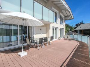 a patio with chairs and an umbrella on a building at Holiday Home Linnehan by Interhome in Fügen