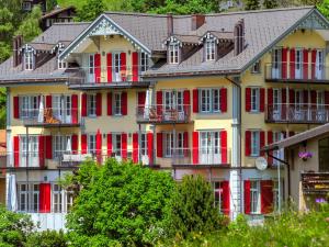 a large building with red doors and windows at Apartment Mittaghorn-3 by Interhome in Wengen