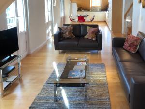 a living room with a couch and a coffee table at Apartment Mittaghorn Apt-8 by Interhome in Wengen +22 photos