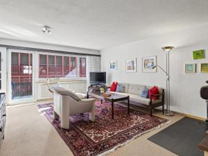 a living room with a couch and a table at Apartment Lang by Interhome in Churwalden