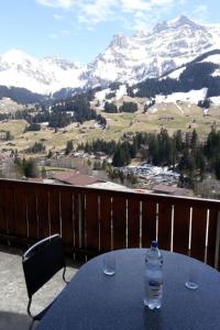 a bottle of water sitting on a table on a balcony at Apartment Adlerhorst by Interhome in Adelboden