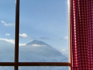 a window with a view of a mountain at Apartment Berg-Seeblick by Interhome in Sundlauenen