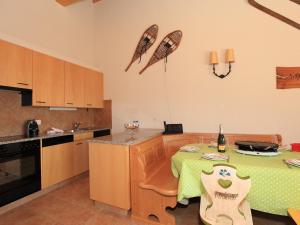 a kitchen with a table with a green table cloth on it at Apartment Fénestral 301 by Interhome in Ovronnaz +10 photos