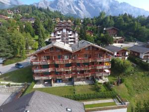 an aerial view of a large building with mountains in the background at Apartment Ardève 13 by Interhome in Ovronnaz