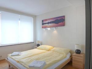 a bedroom with a bed and a painting on the wall at Apartment Haus Gertsch Apt-G by Interhome in Wengen