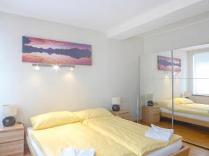 a bedroom with two beds and a mirror at Apartment Haus Gertsch Apt-G by Interhome in Wengen