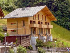a large wooden house on the side of a hill at Apartment Roossi Apt- 1 by Interhome in Wengen