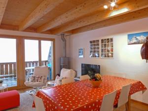 a dining room with a table and chairs at Apartment Racer's Retreat-2 by Interhome in Wengen
