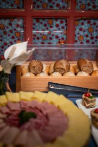 a display of breads and pastries on a table at Pousada Cacau in Praia do Rosa
