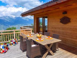 a wooden deck with a table and chairs on a cabin at Chalet D'Arby by Interhome in Nendaz
