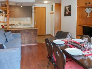 a living room with a table and a couch at Apartment Beau-Séjour 24 by Interhome in Nendaz