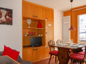 a living room with a table and a television at Apartment Beau-Séjour 24 by Interhome in Nendaz