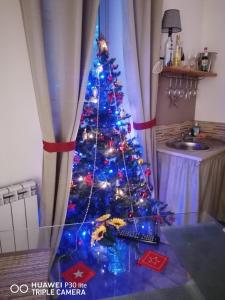 a christmas tree with blue lights in a room at BELLA PALERMO in Palermo
