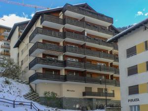 a building with balconies on the side of it at Apartment Mirador-2 by Interhome in Zermatt