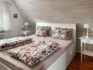 a bedroom with two beds and two night stands at Holiday Home Hexenhuus by Interhome in Hage
