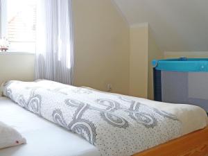 a bedroom with a bed with a white bedspread at Holiday Home Domek Joanna-2 by Interhome in Łeba
