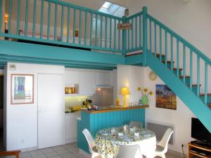 a dining room with a table and a staircase at Apartment Horizon-2 by Interhome in Mimizan-Plage