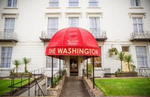 a red umbrella in front of a building at The Washington in Bristol