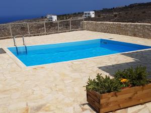 a blue swimming pool on a stone patio at Holiday Home Puntiti 3 by Interhome in Kókkinon Khoríon