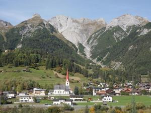 a small town in a valley with mountains in the background at Apartment Stark by Interhome in Pettneu am Arlberg