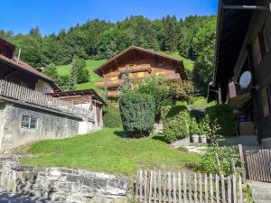 a house on top of a hill with a fence at Apartment La Tour d'Antheme by Interhome in Champéry