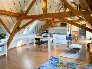 a living room with a table and a kitchen at Studio Arn's Dachstudio by Interhome in Wangenried  