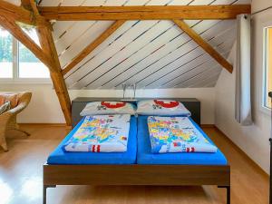 two beds in a room with a attic at Studio Arn's Dachstudio by Interhome in Wangenried   +17 photos
