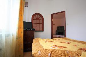 a bedroom with a bed and a dresser and a mirror at Velvet Apartament Kopińska in Warsaw