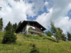 dom na szczycie trawiastego wzgórza w obiekcie Holiday Home Lotte by Interhome w mieście Sirnitz-Sonnseite