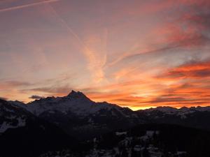 a sunset in the mountains with the sky at Chalet Zan-Fleuron by Interhome in Arveyes