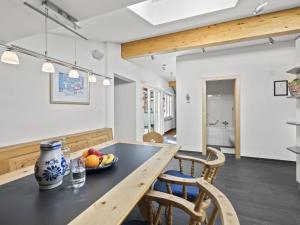 a kitchen and dining room with a wooden table and chairs at Apartment Hutter by Interhome in Churwalden