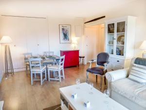 a living room with a table and a couch at Apartment Eden Park by Interhome in Bénerville-sur-Mer