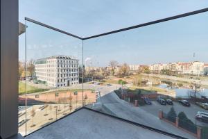 a view of a city from a window in a building at Eleganckie Studia Wyspa Słodowa by Noclegi Renters in Wrocław